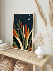 Stylised agave succulent plant illustration with green and orange leaves against a navy, in an alternate framed mockup