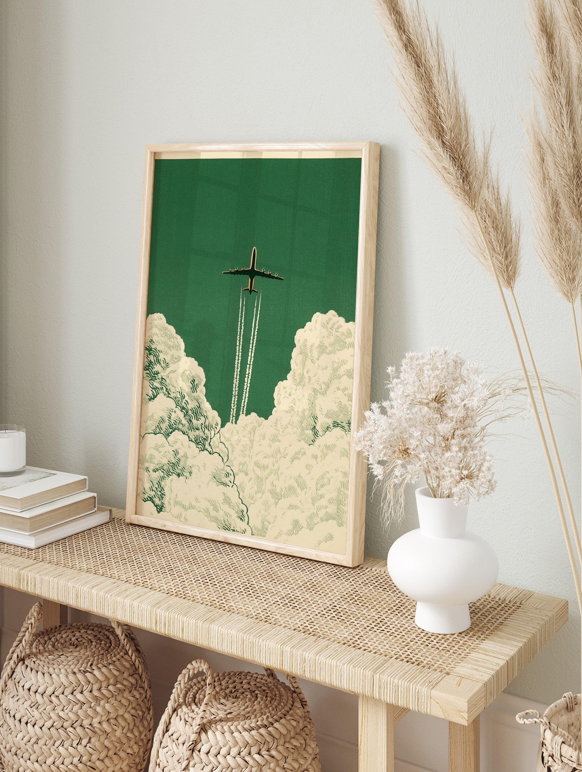 Vintage style airplane art print soaring through clouds on a deep green background, in an alternate framed mockup