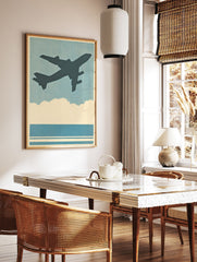 Vintage airplane poster featuring a dark silhouette of a plane flying in a blue sky above clouds and water, with a halftone texture. - Image 2