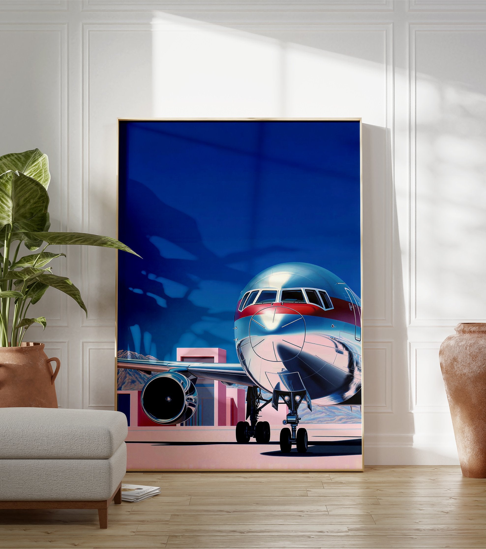Modern airplane wall art print with a silver and red jet on a tarmac under a blue sky, featuring pink buildings. - Image 3