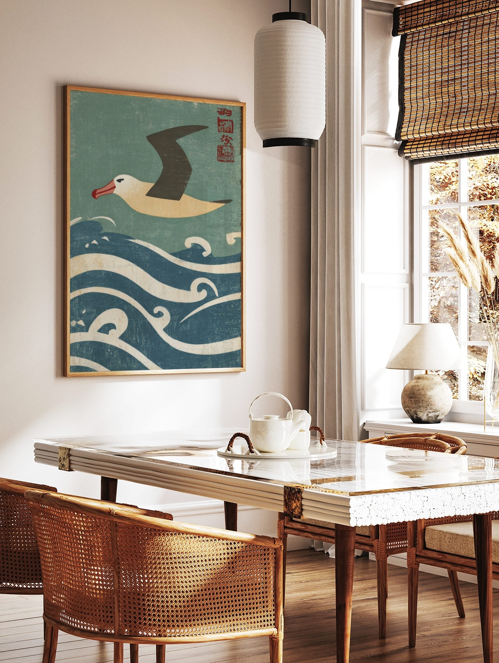 Japanese style albatross flying over blue and white waves with red kanji seal in the corner, in a styled room mockup