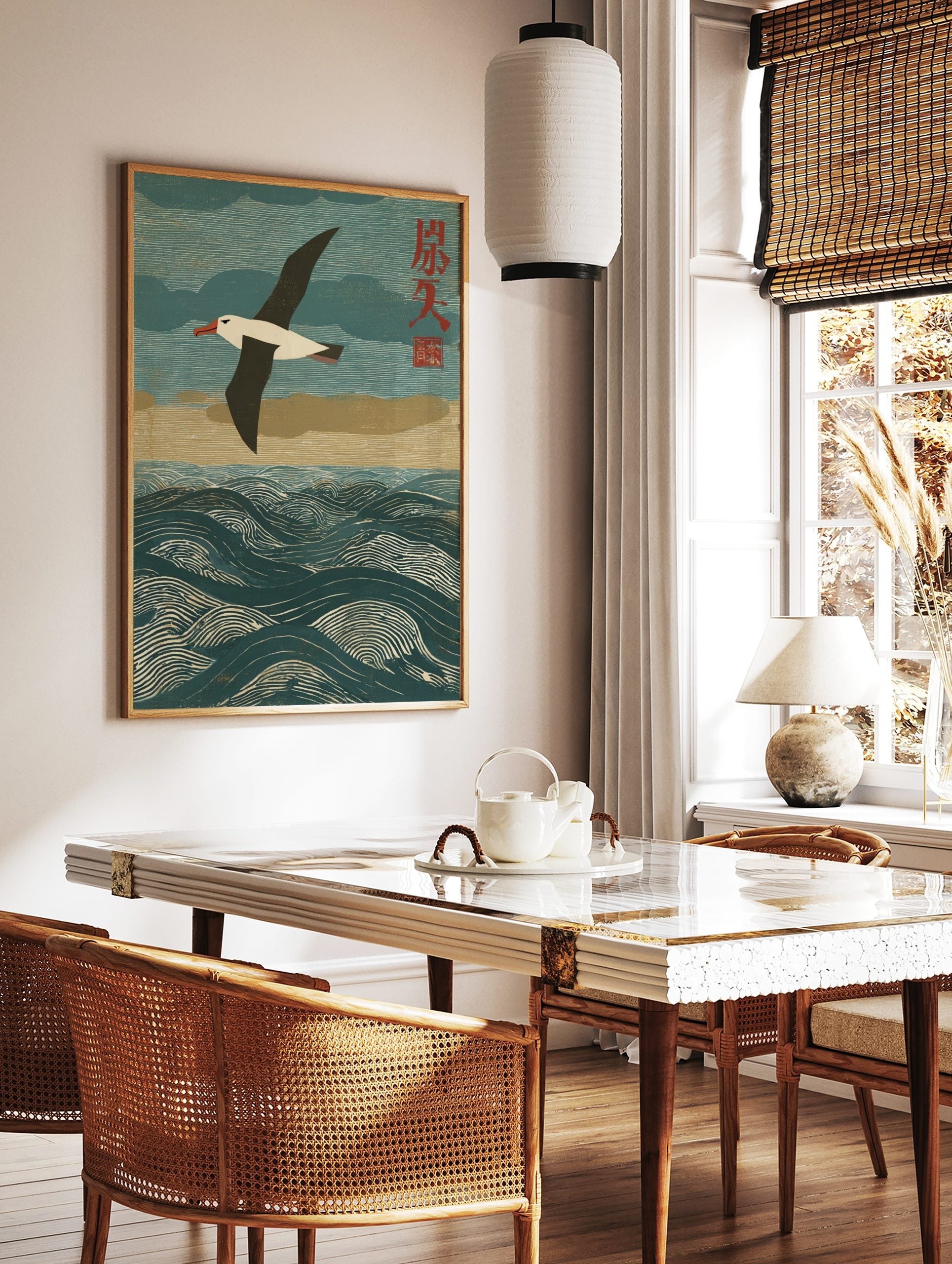 Albatross seabird flying over textured blue ocean waves with red Japanese characters in a woodblock, in a styled room mockup