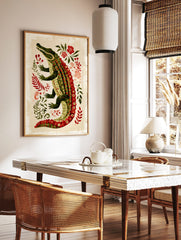 Illustrative green alligator with red patterned scales and red eyes, surrounded by green leaves and, in a styled room mockup