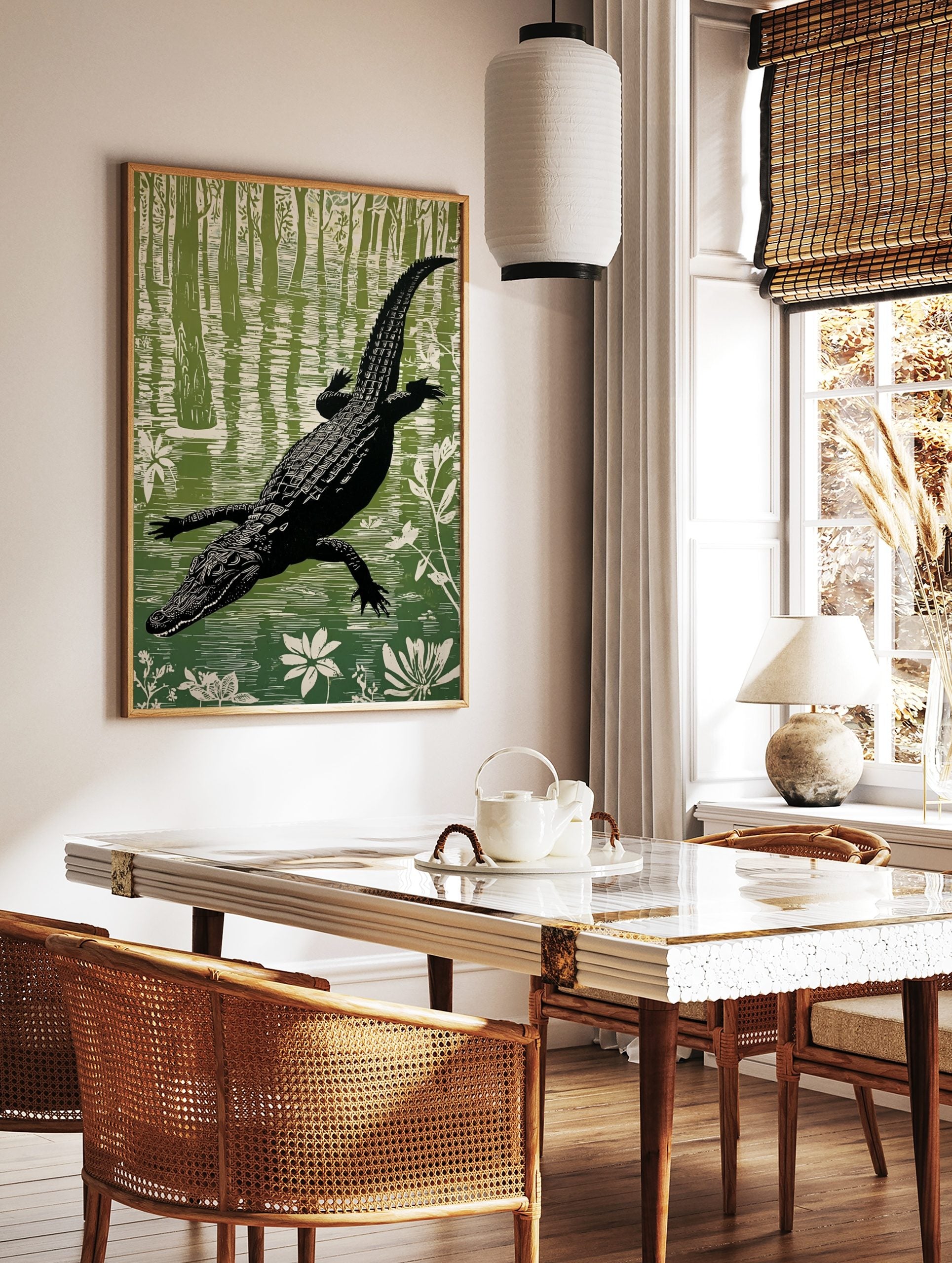 Illustrative linocut style print of a black alligator swimming in a green and white swamp with, in a styled room mockup