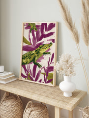 Green alligator illustration against purple and cream abstract brushstrokes, in an alternate framed mockup