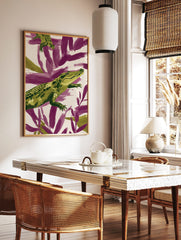 Green alligator illustration against purple and cream abstract brushstrokes, in a styled room mockup