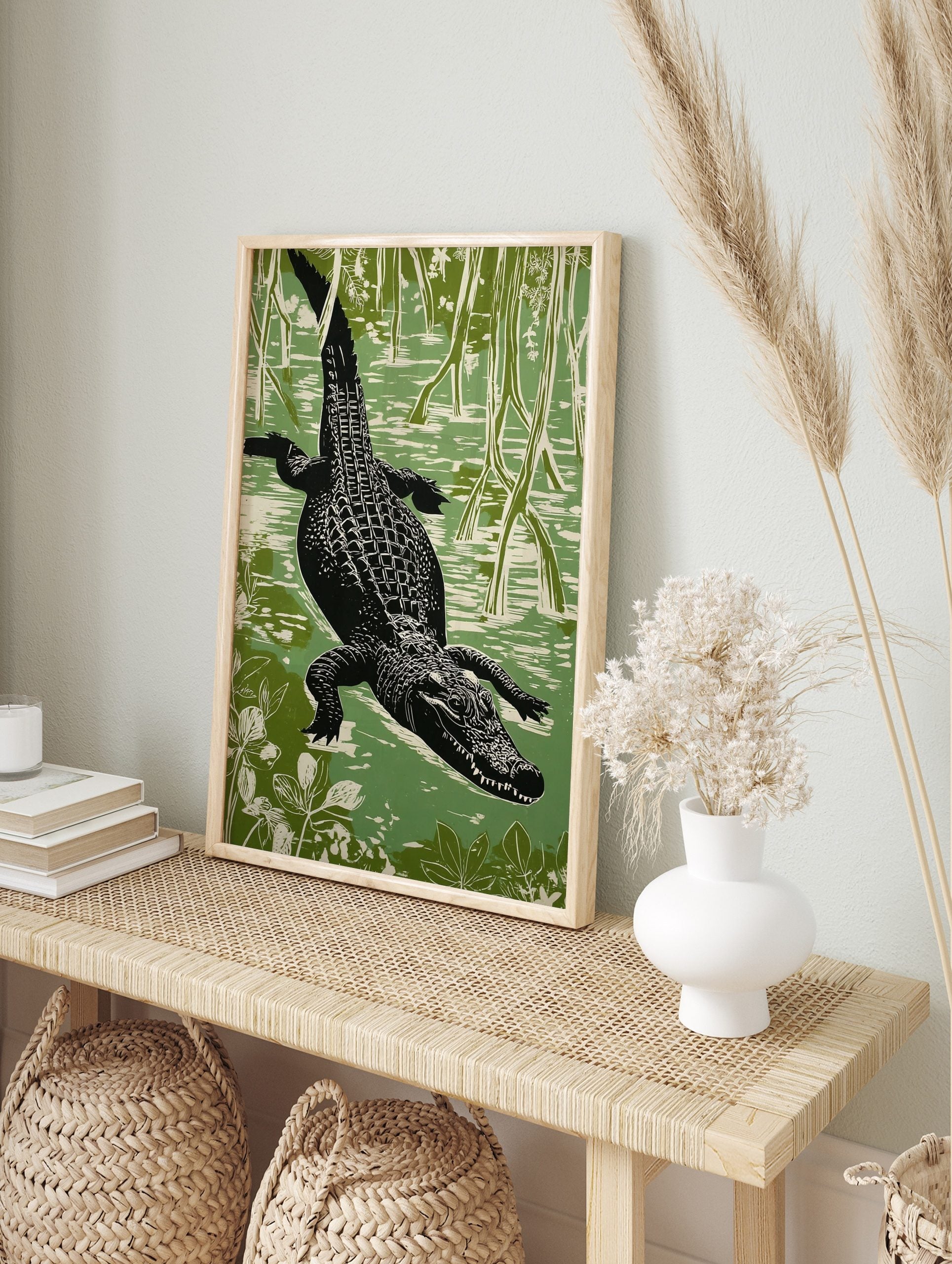 Linocut style alligator swimming through a green swamp, viewed from above, with roots and, in an alternate framed mockup