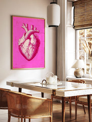 Detailed anatomical heart illustration print in bright pink and off-white with distressed background, in a styled room mockup