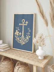 Illustrative beige anchor adorned with botanical flowers and leaves on a blue background, in an alternate framed mockup