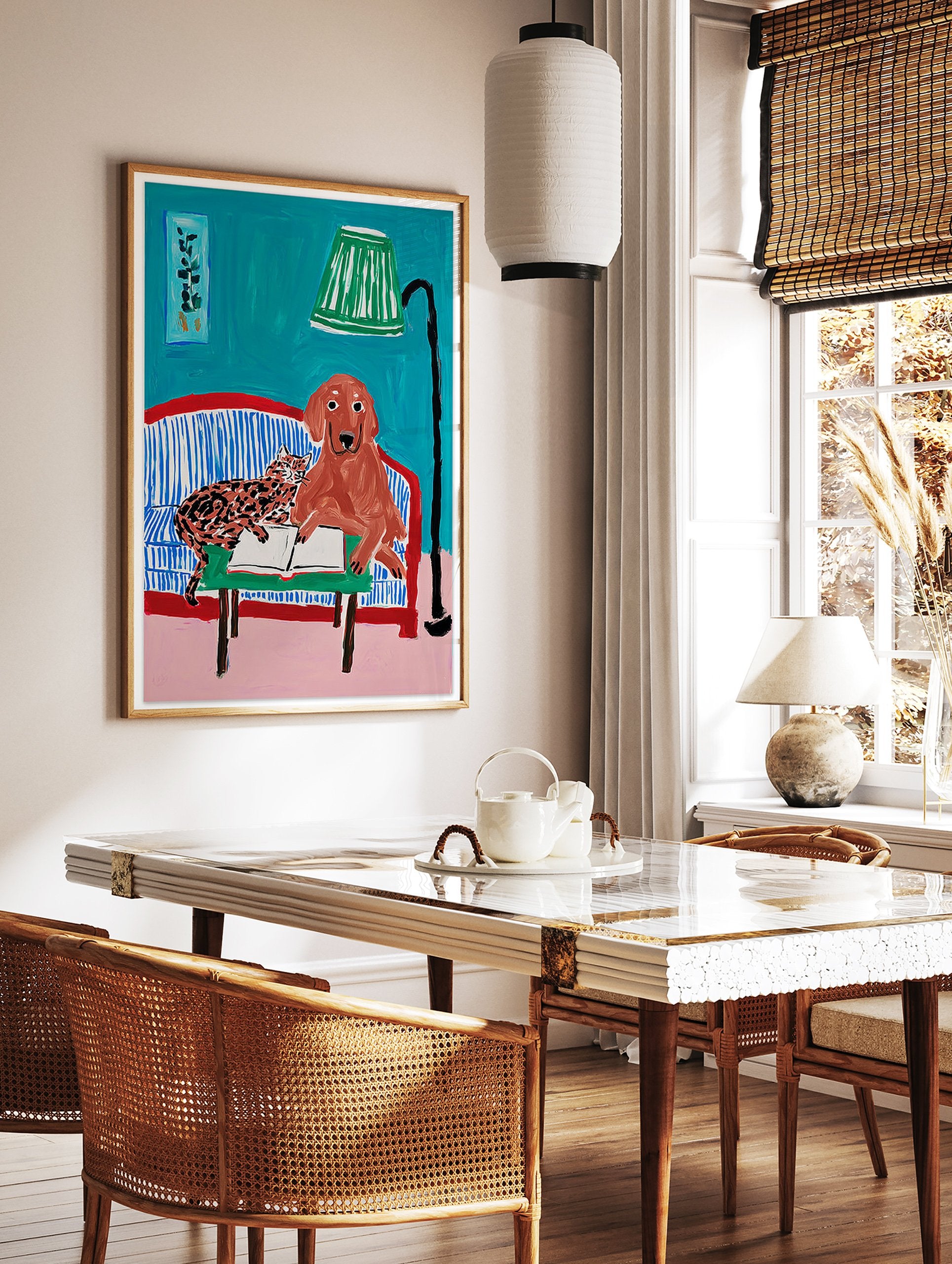 Illustrative animal wall art featuring a brown dog and a spotted cat reading a book on a blue striped couch with a green lamp. - Image 2