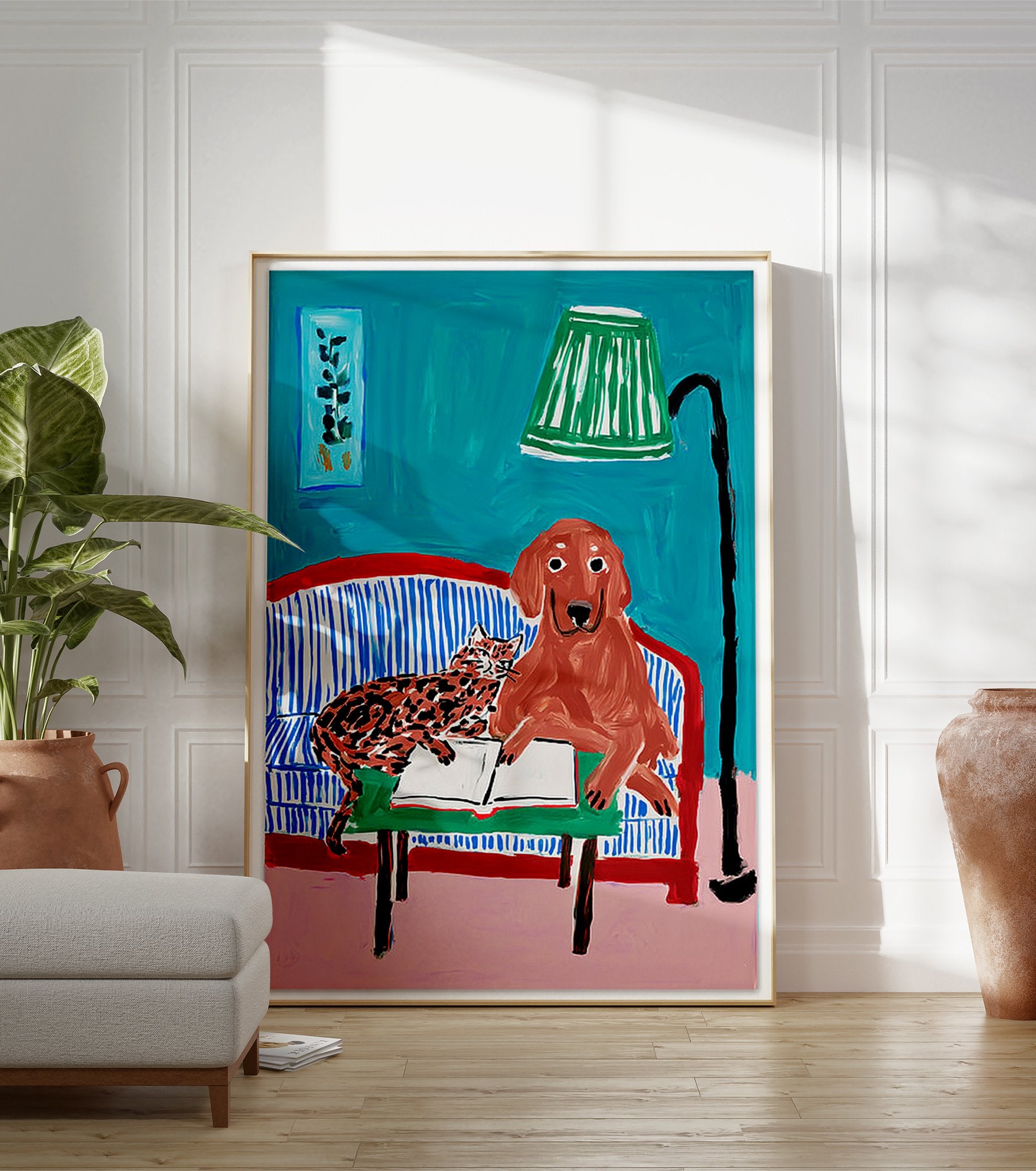 Illustrative animal wall art featuring a brown dog and a spotted cat reading a book on a blue striped couch with a green lamp. - Image 3