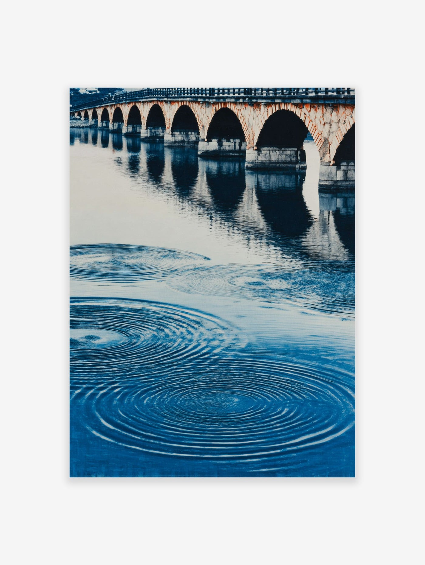 A blue water arch bridge poster featuring a stone bridge with multiple arches reflected in rippling water.