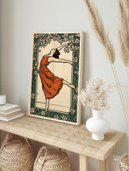 Art Nouveau dancer in terracotta dress, arms outstretched, framed by white and green floral, in an alternate framed mockup