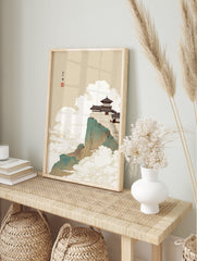 Asian landscape wall art featuring a traditional temple on a teal and brown mountain cliff, surrounded by white and gold clouds. - Image 3