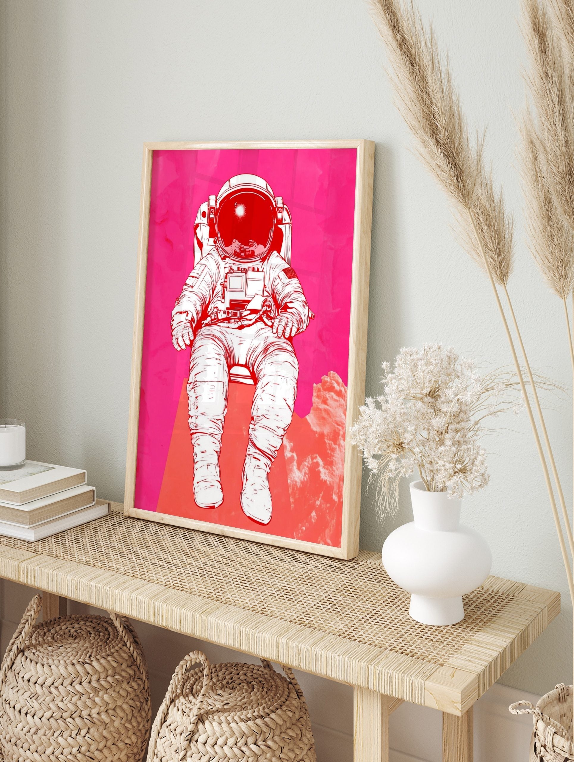 Illustrative astronaut in white space suit against a vibrant pink and red textured, in an alternate framed mockup