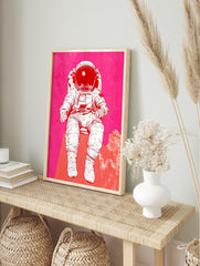 Illustrative astronaut in white space suit against a vibrant pink and red textured, in an alternate framed mockup