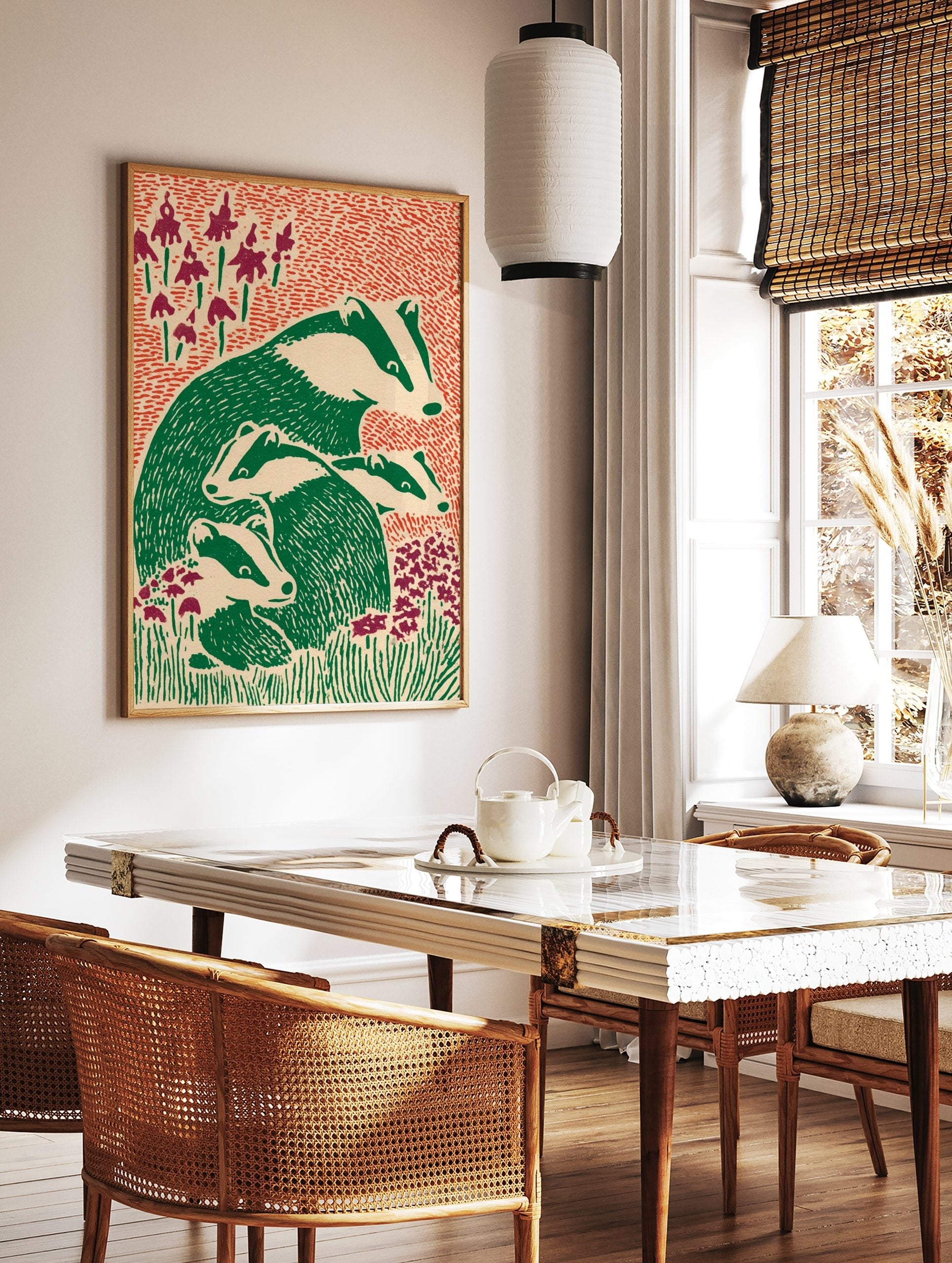 Illustrative print of an adult badger and three young badgers in green and off-white, surrounded by, in a styled room mockup