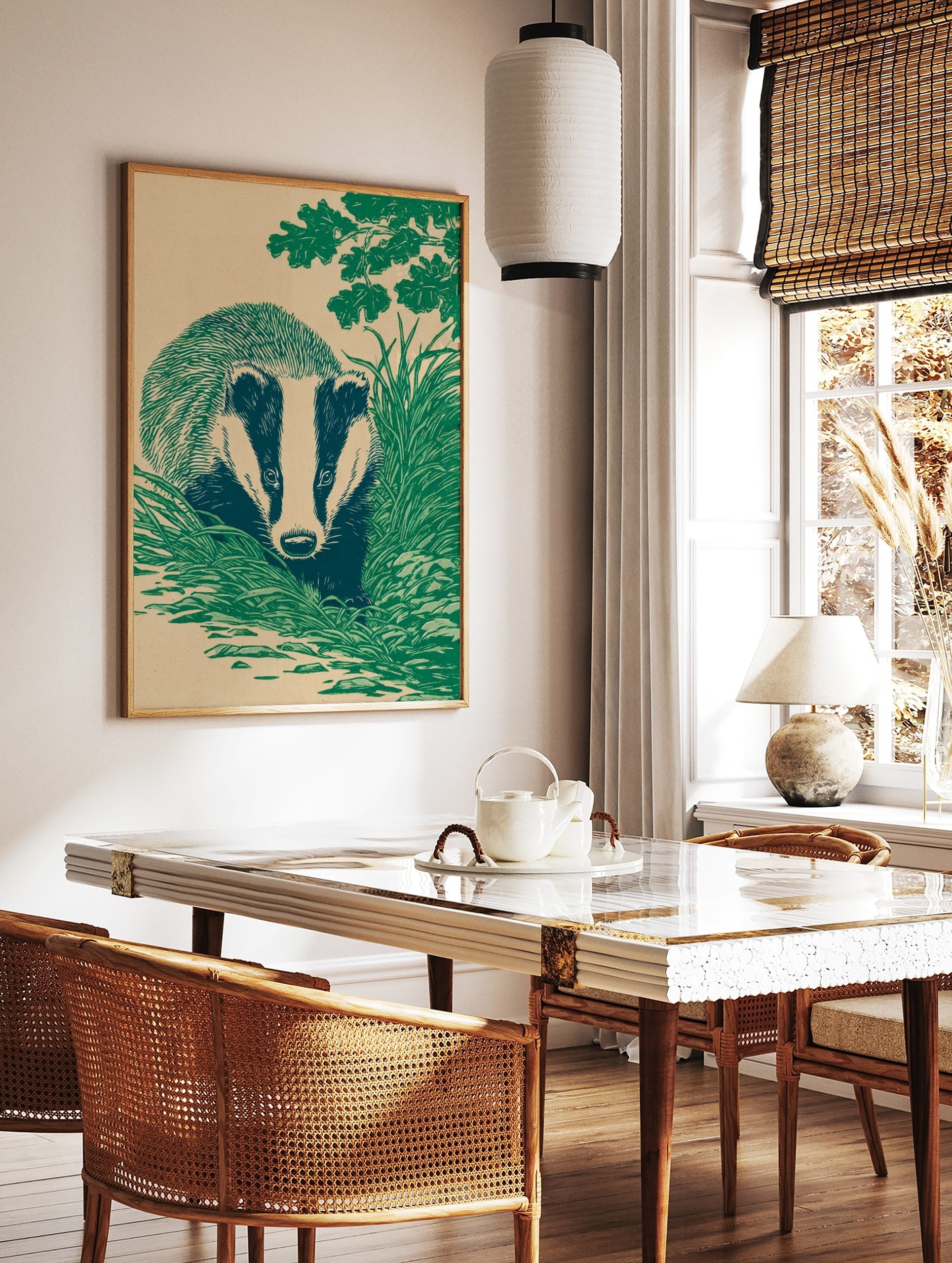 Illustrative linocut style print of a badger with striped face, hidden in green grass under oak, in a styled room mockup