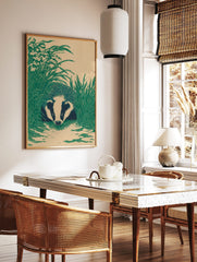 Illustrative badger with striped face peeking through tall green grass on a beige background, in a styled room mockup