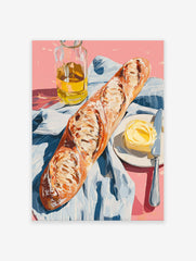 A poster depicting a still life of a baguette, a pat of butter with a knife on a plate, and a bottle of olive oil on a pink surface with a blue and white striped cloth.