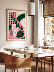 Retro illustration of a baguette, cheese, and grapes in pink and dark green on a checkerboard, in a styled room mockup