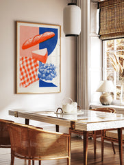 Graphic food illustration of a baguette, cheese and grapes with a red gingham and blue background, in a styled room mockup
