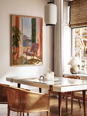 Watercolour painting of a balcony with a striped armchair, open shutter, potted plant, and city, in a styled room mockup