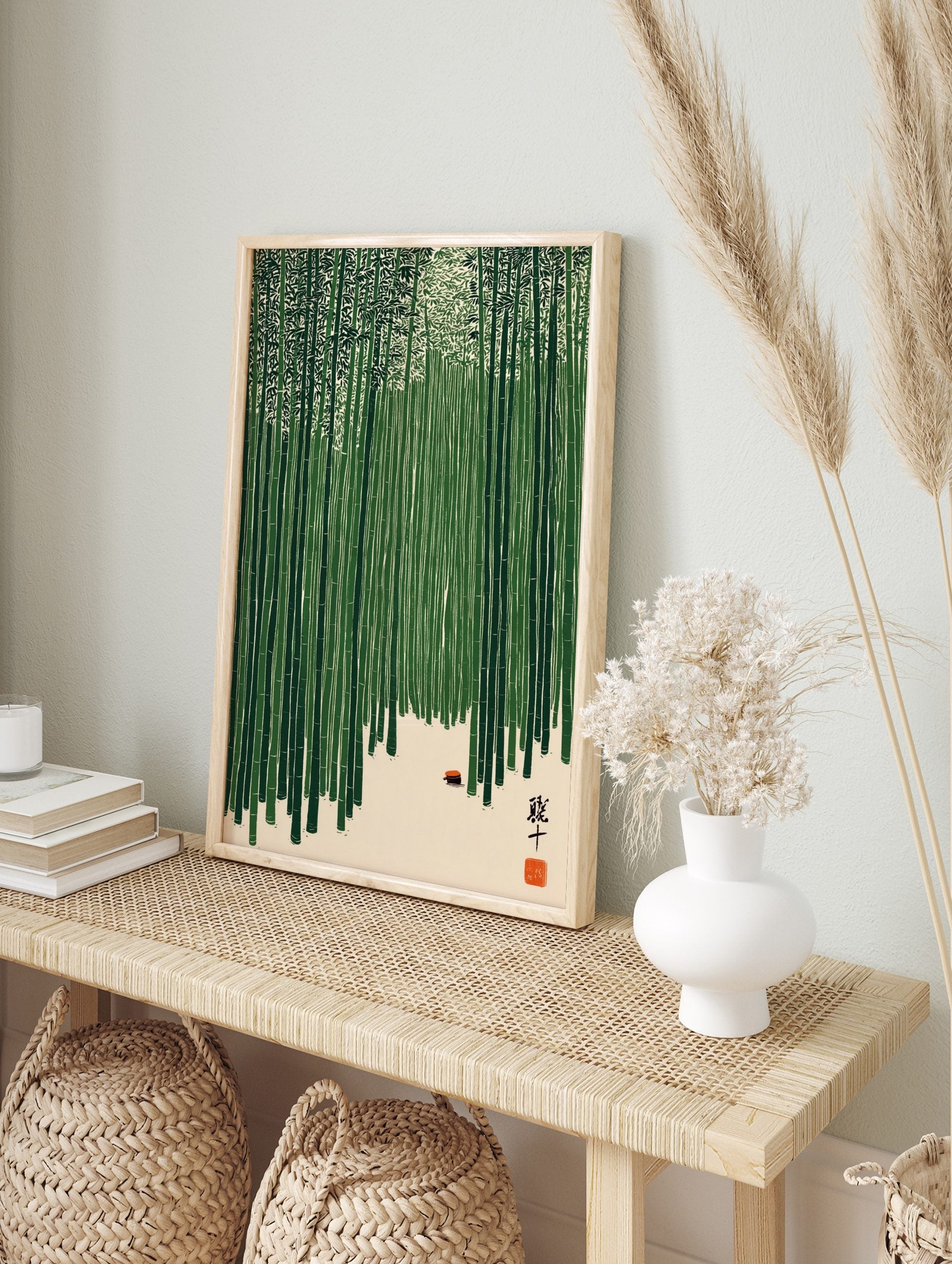 Illustrative bamboo forest wall art with green stalks, light ground, small red object, and, in an alternate framed mockup