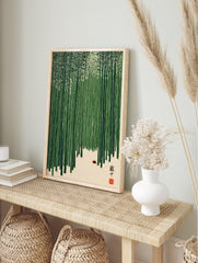 Illustrative bamboo forest wall art with green stalks, light ground, small red object, and, in an alternate framed mockup