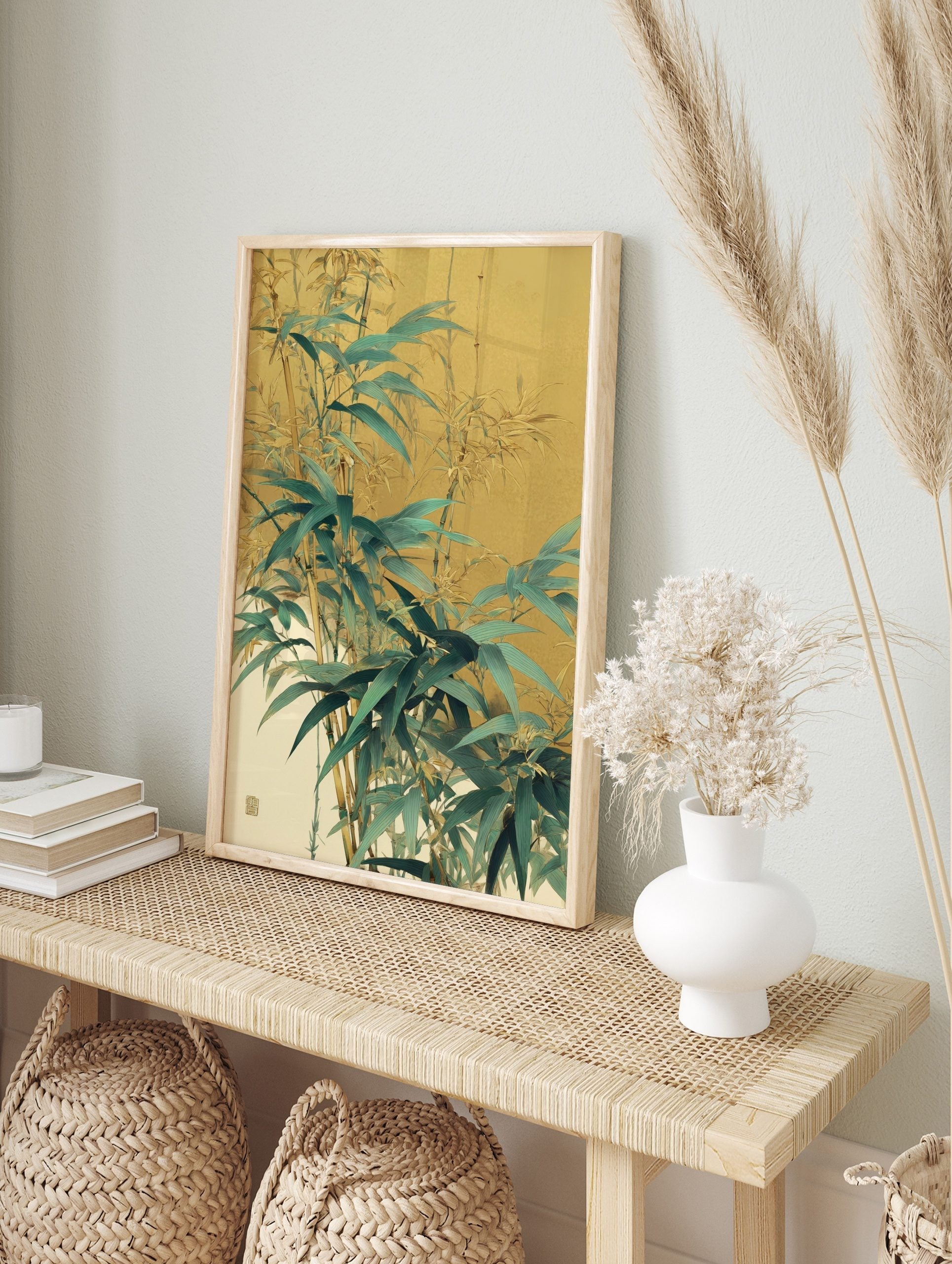 Illustrative bamboo leaves and stalks in green and gold against a muted warm background, in an alternate framed mockup