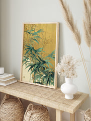 Illustrative bamboo leaves and stalks in green and gold against a muted warm background, in an alternate framed mockup
