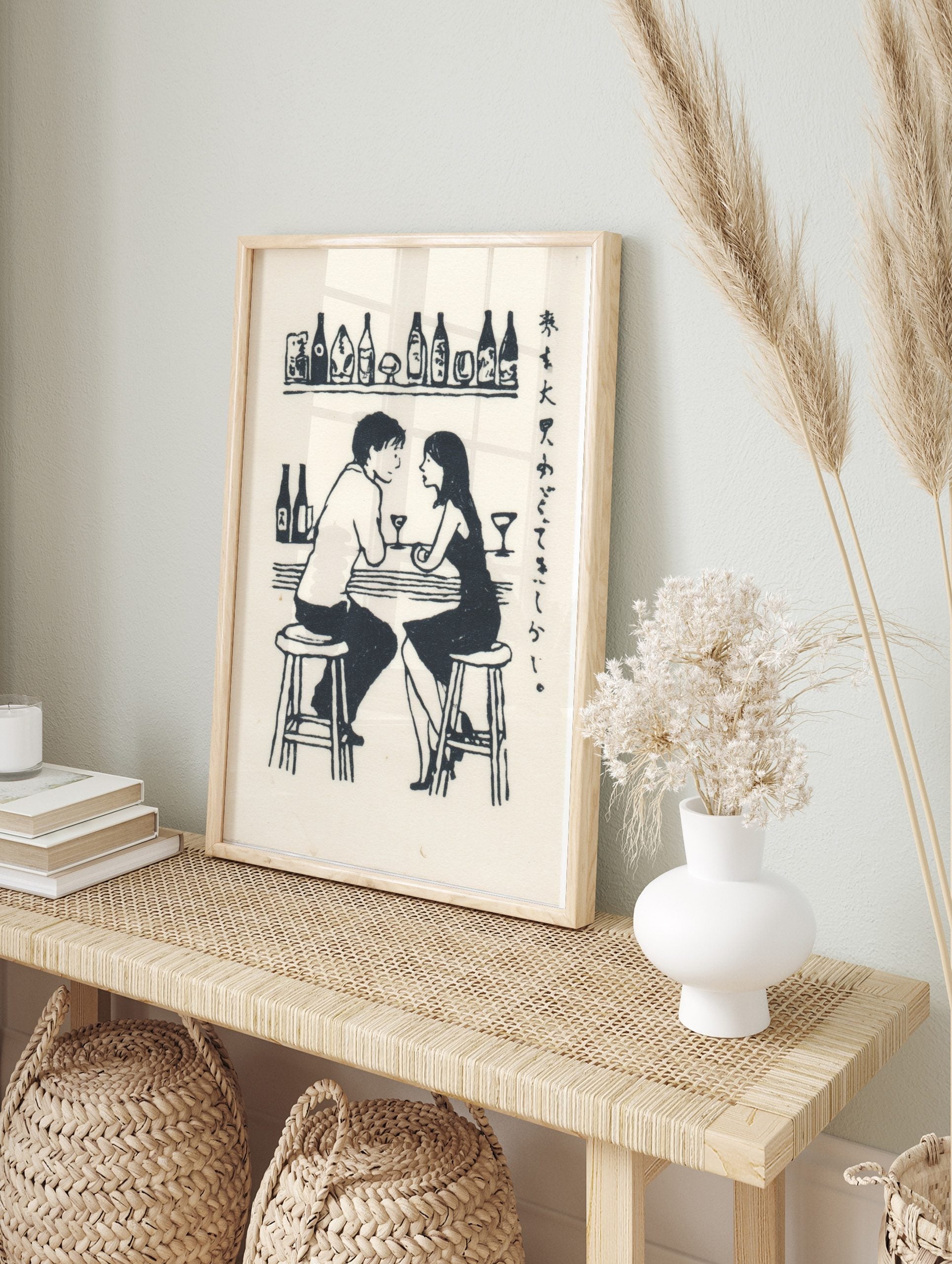 Monochrome illustrative print of a man and woman talking at a bar, with drinks and Japanese, in an alternate framed mockup