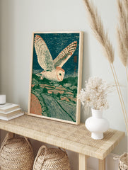 Barn owl flying over a rural landscape at night, in a Japanese woodblock art print style, in an alternate framed mockup