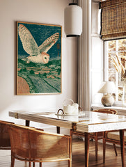 Barn owl flying over a rural landscape at night, in a Japanese woodblock art print style, in a styled room mockup