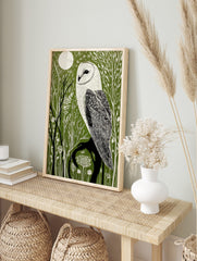 Illustrative barn owl print with white owl on a dark branch against a dark green forest and, in an alternate framed mockup