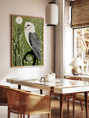 Illustrative barn owl print with white owl on a dark branch against a dark green forest and white, in a styled room mockup