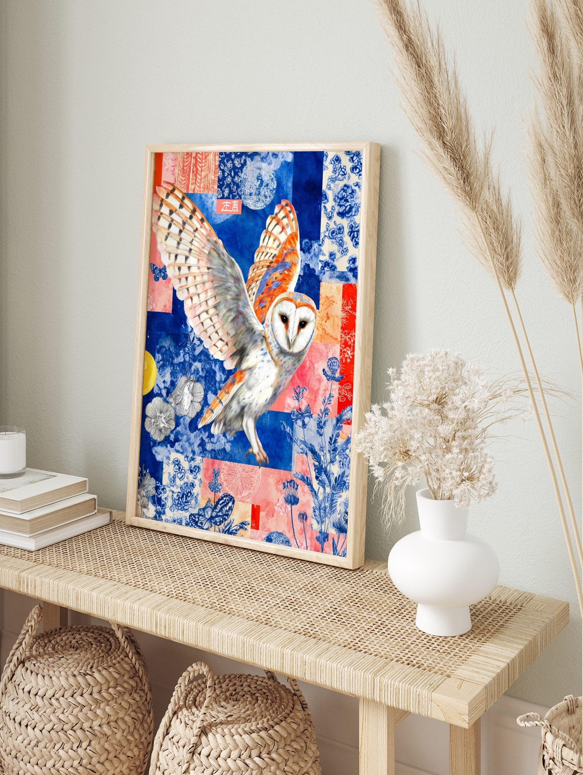 Barn owl with spread wings against a blue and coral collage background with floral patterns, in an alternate framed mockup