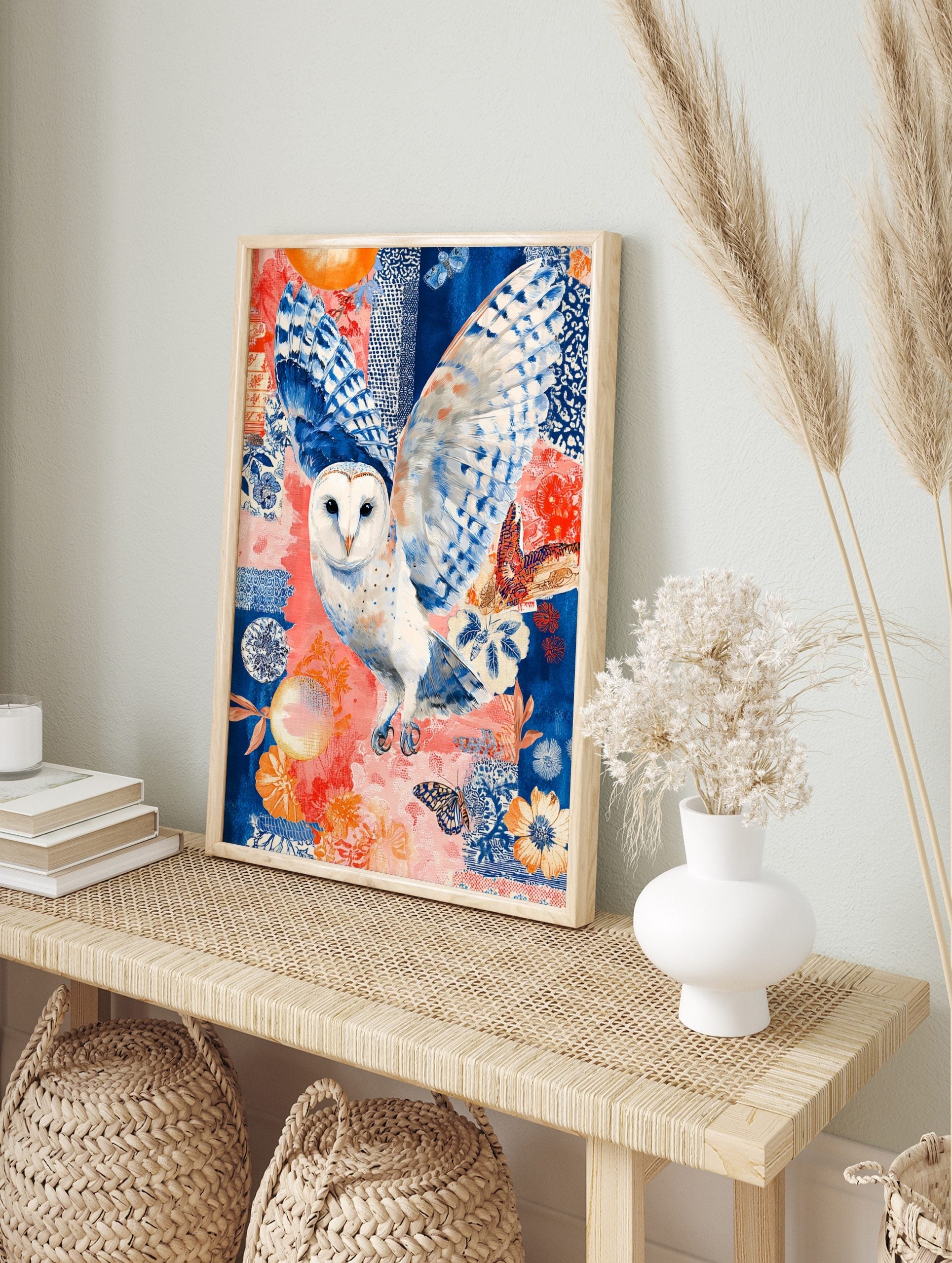 Illustrative barn owl in flight with blue and white wings against a coral and blue patterned, in an alternate framed mockup