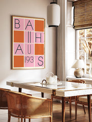 Bauhaus poster with a grid design featuring black letters spelling 'BAUHAUS 193S' on pink squares, interspersed with solid orange squares. - Image 2