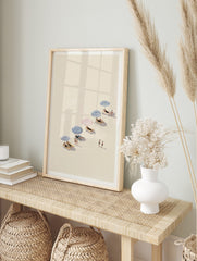 Illustrative beach day wall art with people relaxing under blue and red striped umbrellas on a sandy shore. - Image 2