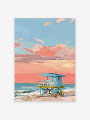 Painted lifeguard hut on a beach with a coral pink and blue sunset sky and ocean waves