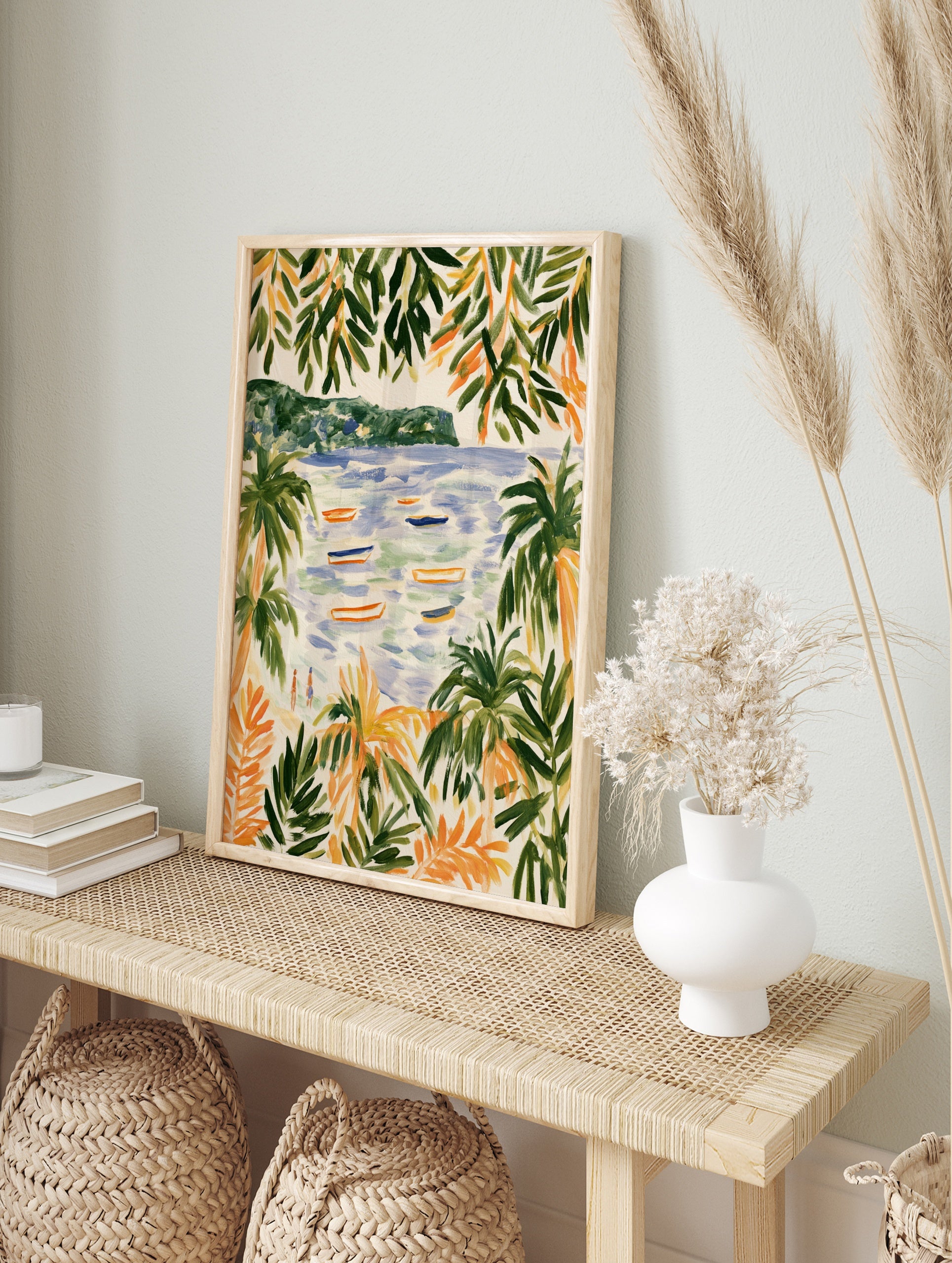 Coastal beach scene with palm trees, boats on water, and distant hills, illustrative art print, in an alternate framed mockup