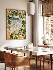 Coastal beach scene with palm trees, boats on water, and distant hills, illustrative art print, in a styled room mockup