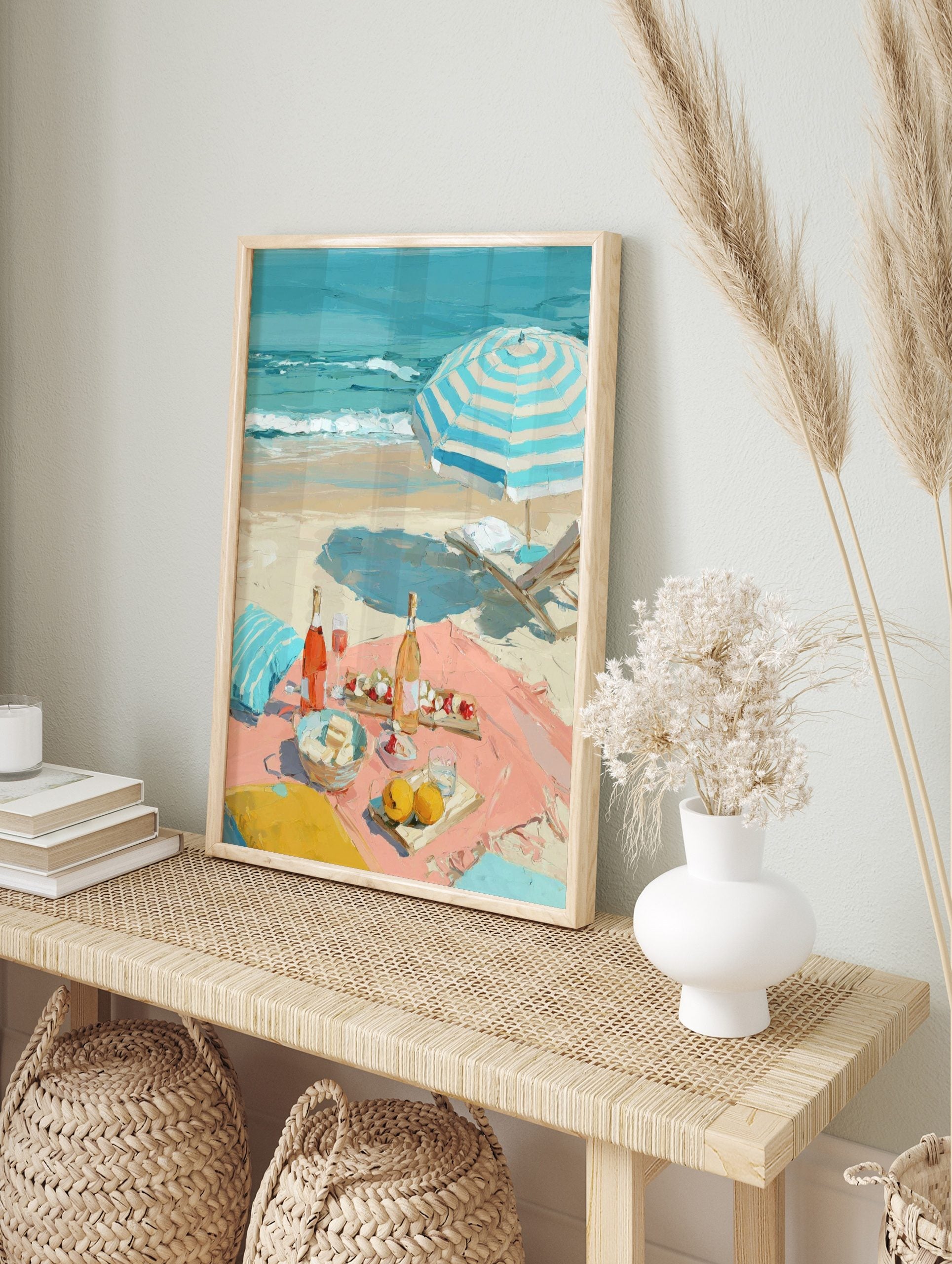 Impressionist painting of a beach picnic with rosé wine, fruit, a striped umbrella, and ocean, in an alternate framed mockup