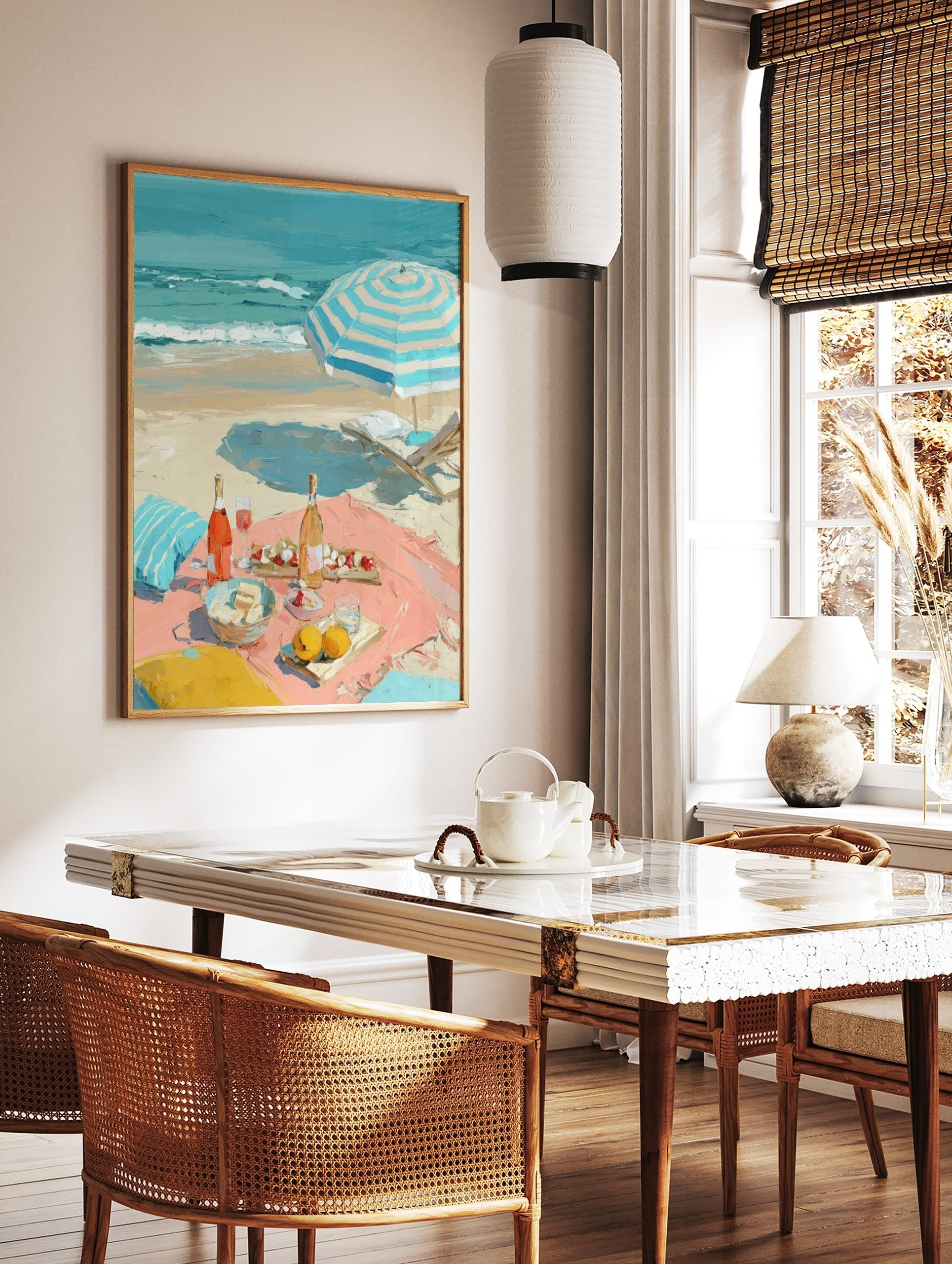 Impressionist painting of a beach picnic with rosé wine, fruit, a striped umbrella, and ocean waves, in a styled room mockup
