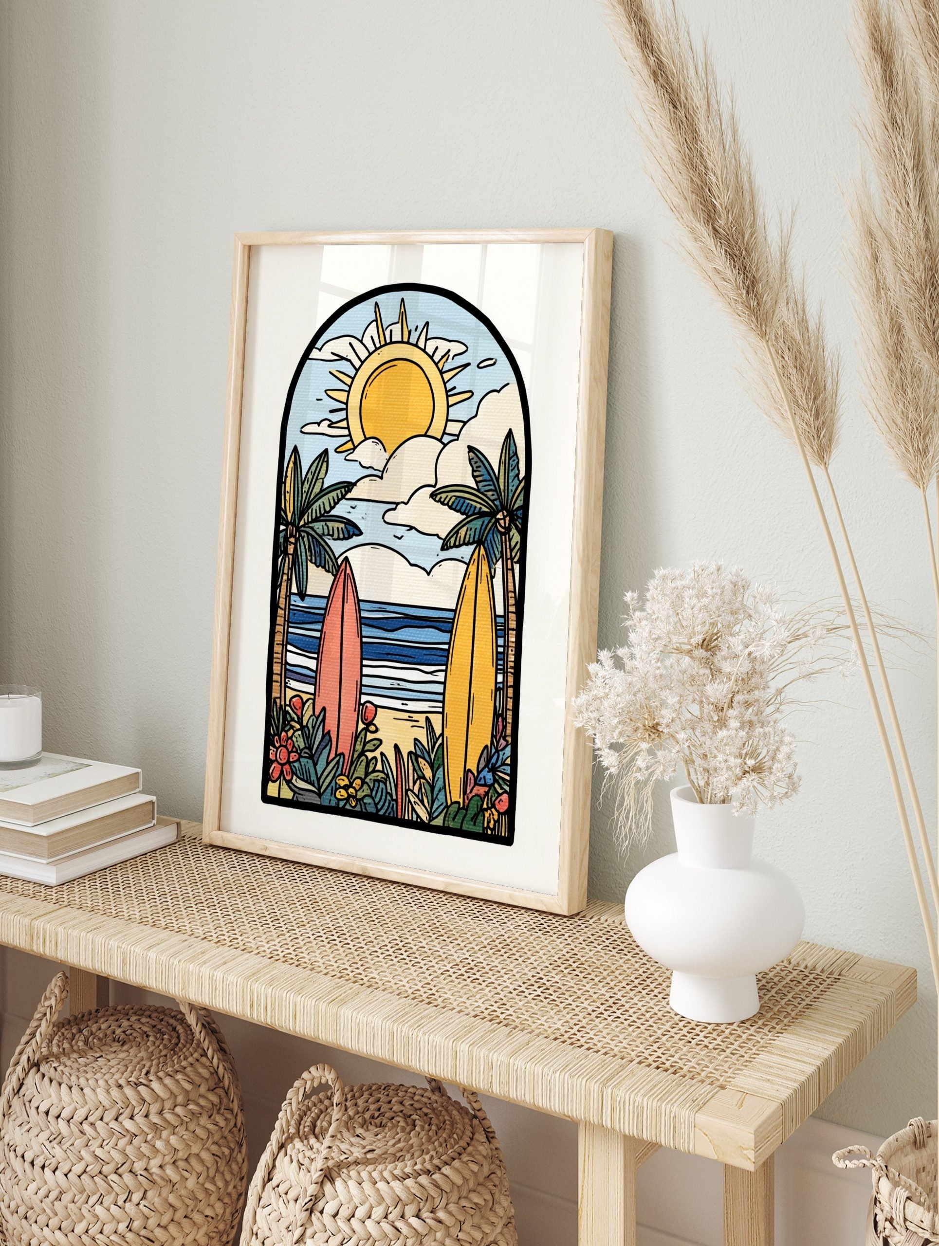 Illustrative beach scene art print with two surfboards, palm trees, ocean, sun, and clouds in, in an alternate framed mockup