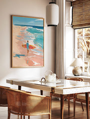 Impressionist painting of a surfer with red and yellow board walking on a peach-toned beach towards, in a styled room mockup