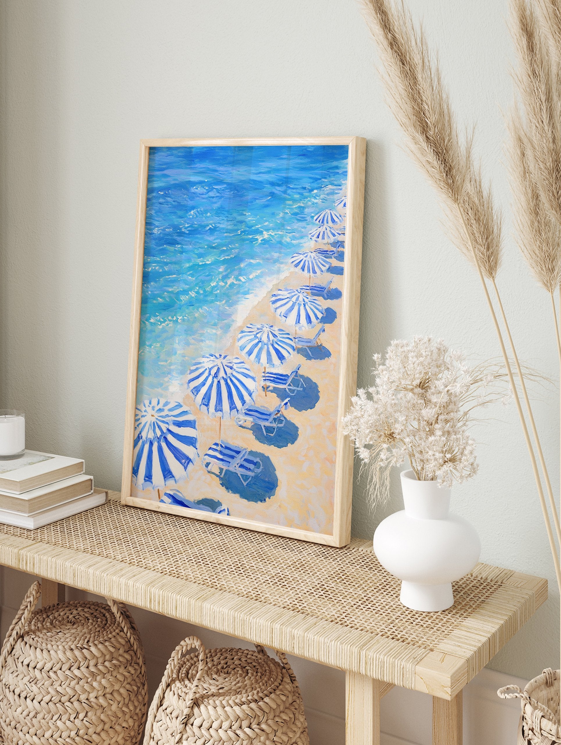 Blue Beach Umbrellas poster showing a painting of a sandy beach with striped umbrellas, lounge chairs, and blue ocean waves. - Image 4