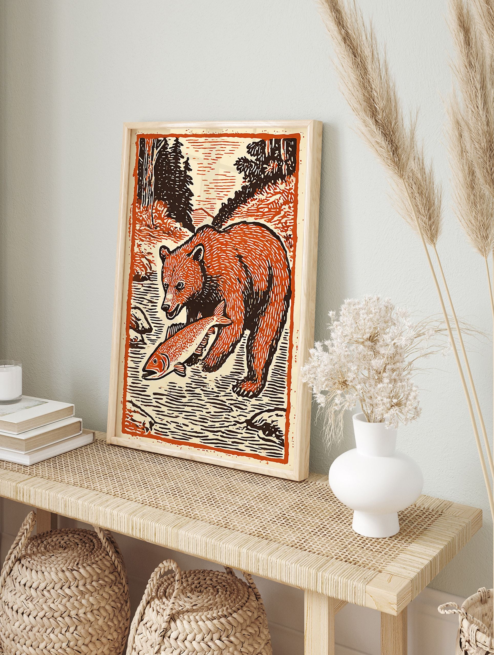Woodcut style bear art print of a brown bear standing in a river holding an orange fish, surrounded by trees. - Image 3