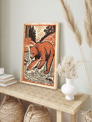 Woodcut style bear art print of a brown bear standing in a river holding an orange fish, surrounded by trees. - Image 3
